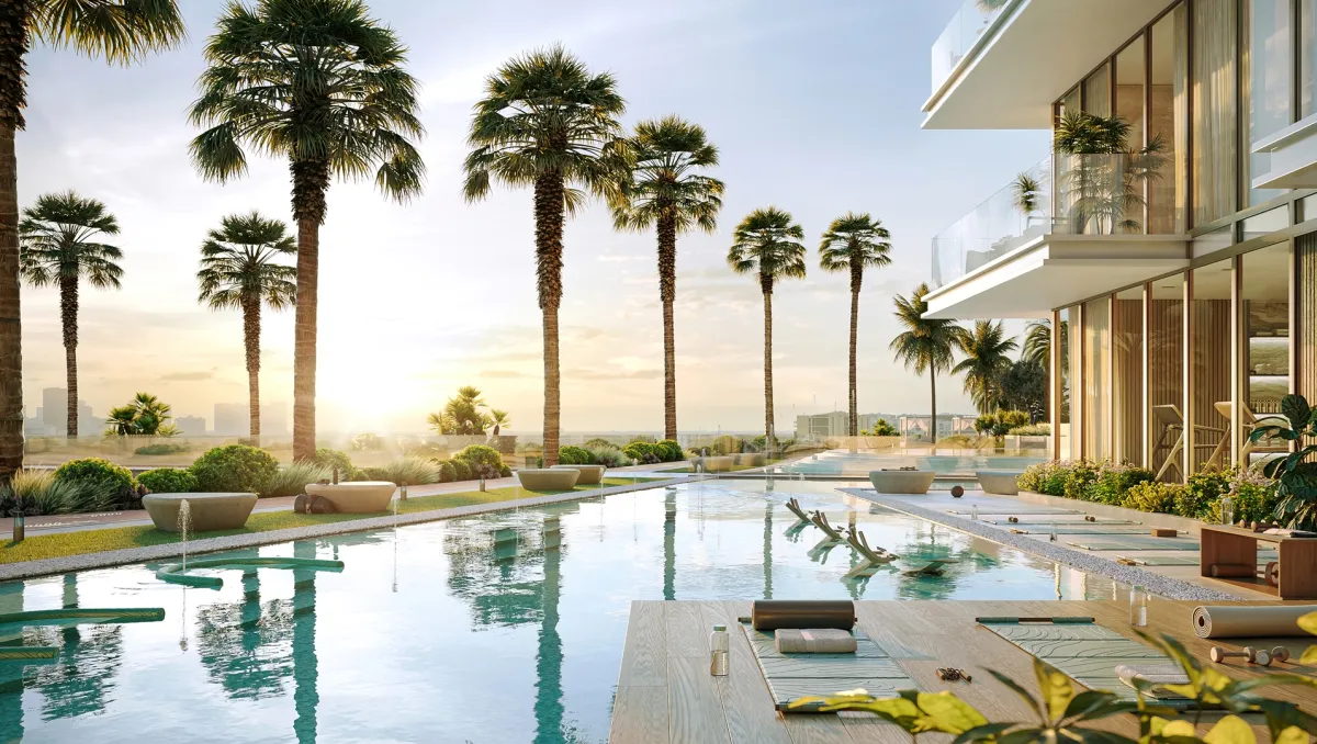 Palm-lined resort pool at sunset at Bab Al Qasr Residence 77
