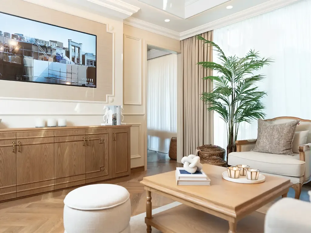 Living and media lounge in a Bab Al Qasr residence with timber console and panelled walls
