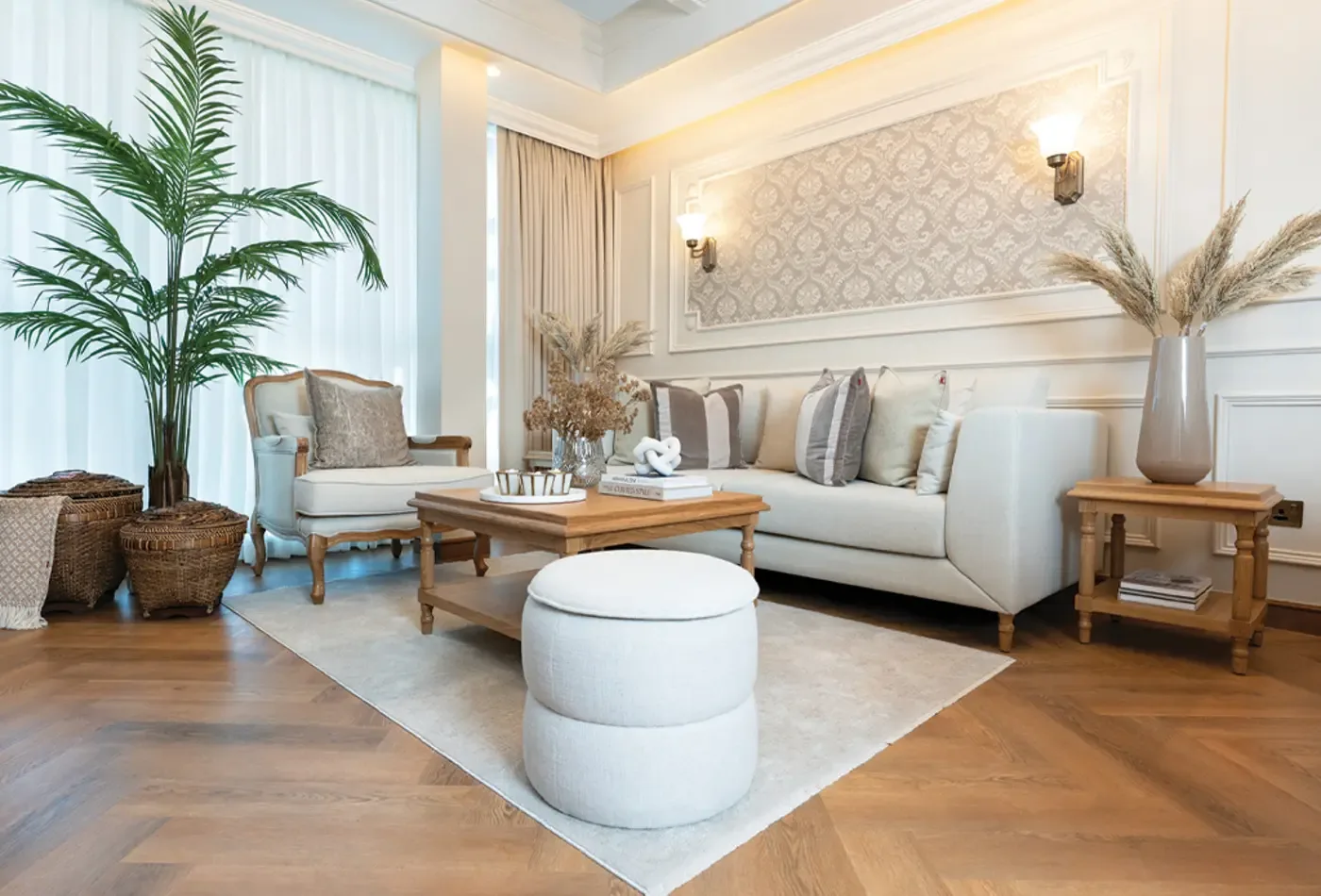 Living room in a Bab Al Qasr residence with herringbone parquet, panelled walls and brass sconces