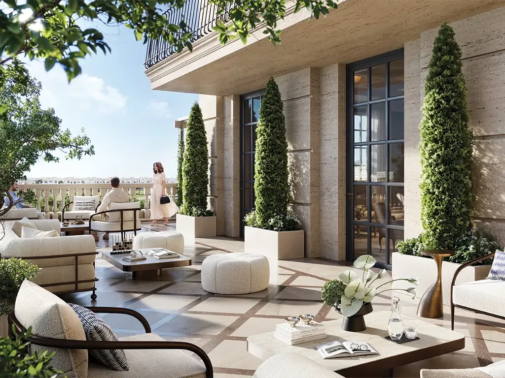 Shaded podium terrace with outdoor seating and clipped topiary at a Bab Al Qasr residence
