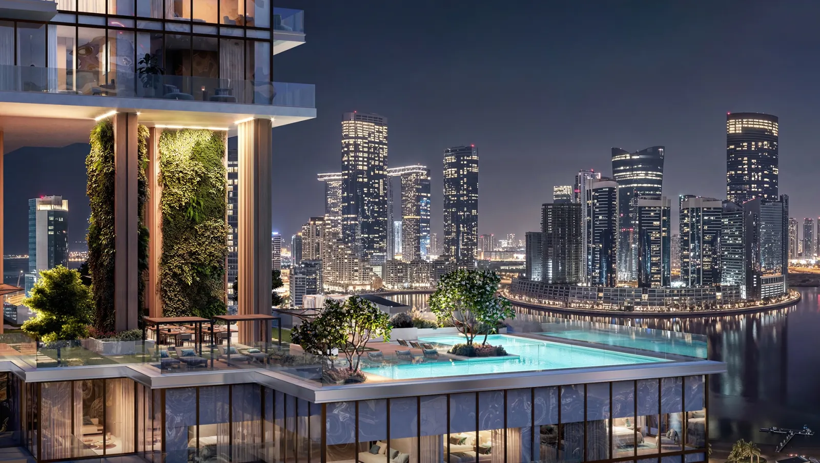 Infinity pool at Bab Al Qasr Residence 77 overlooking the illuminated Al Reem Island skyline at night